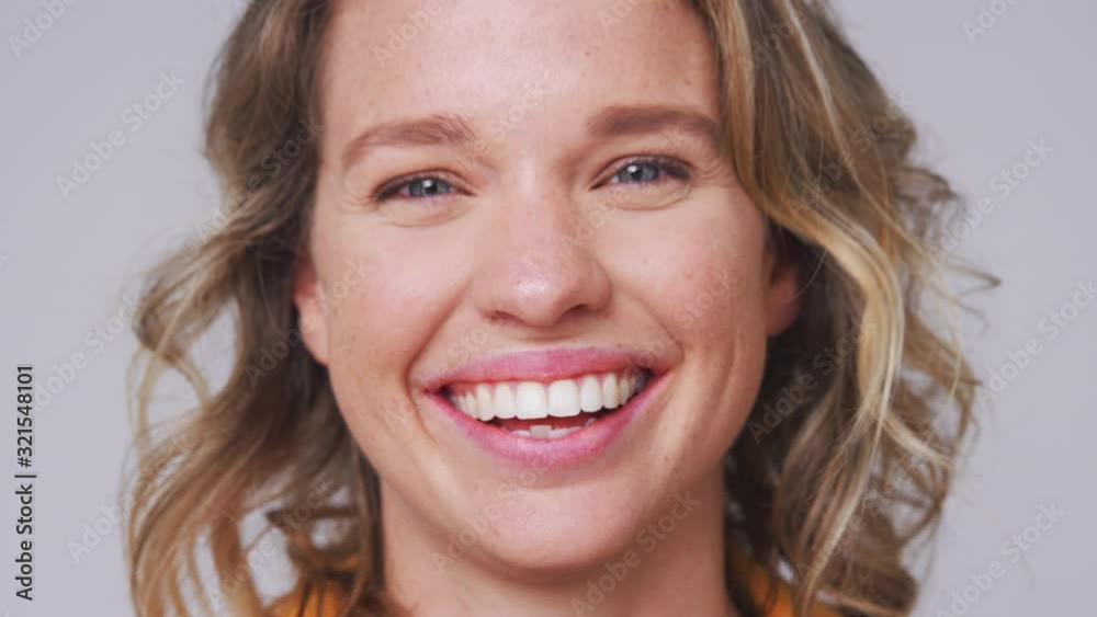 Close Up Head And Shoulders Studio Shot Of Woman Laughing At Camera In Slow Motion Close Up Head And Shoulders Studio Shot Of Woman Laughing At Camera In Slow Motion