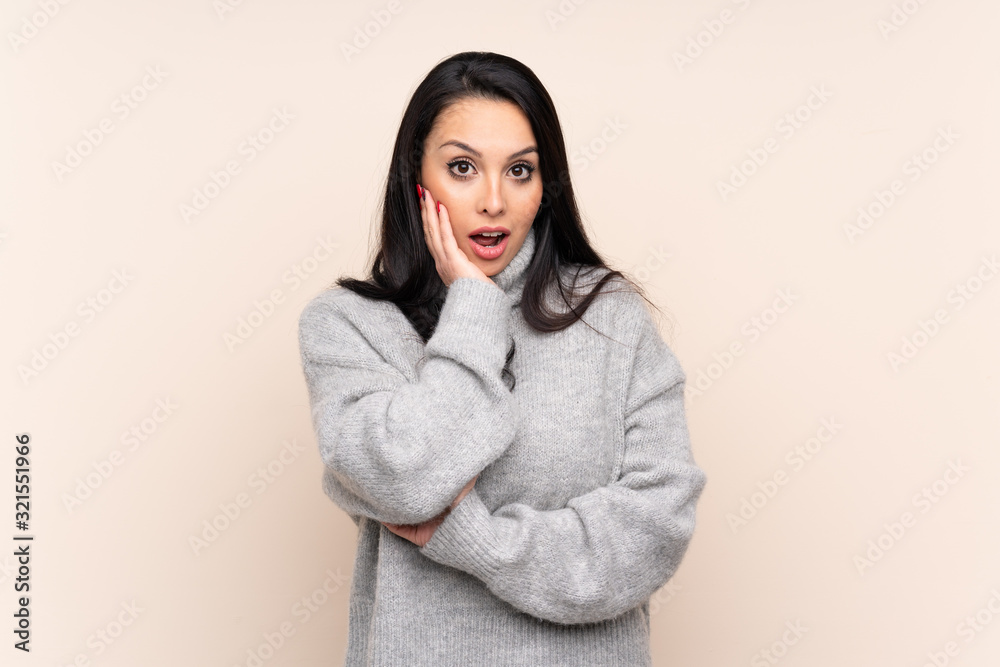 Young Colombian girl over isolated background surprised and shocked while looking right Young Colombian girl over isolated background surprised and shocked while looking right