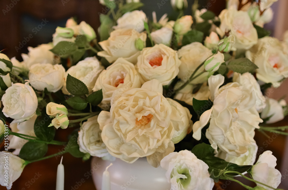 A large and lush bouquet of white flowers in a vase. A large and lush bouquet of white flowers in a vase.