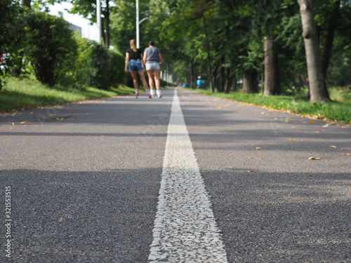 Wallpaper Mural Rollerblading. Holidays, active people and friendship concept. Young girls on roller skates riding outdoors on the city park Torontodigital.ca