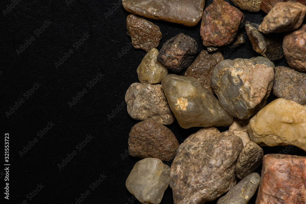 multicolored stones in close-up on a black background multicolored stones in close-up on a black background