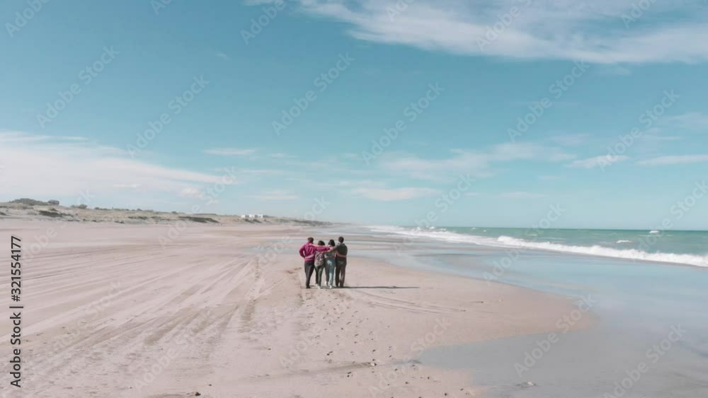 Friends walking, double date walking on the shore of the pacific ocean, aerial view. 4k Friends walking, double date walking on the shore of the pacific ocean, aerial view. 4k