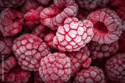 Red frozen raspberries background. Close up  berry background