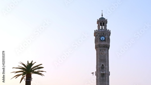 Clock tower and flying birds at konak sqaure city center of izmir.