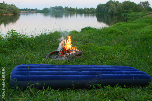 summer vacation by the river with fire and air mattress