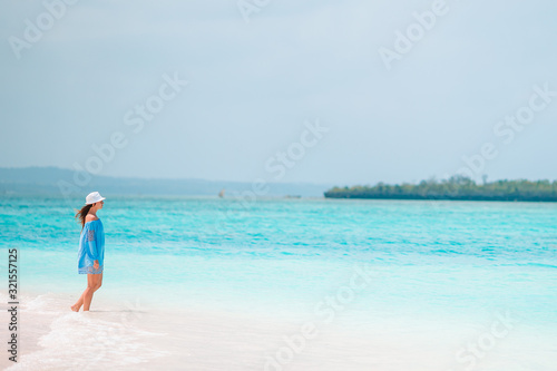 Young fashion woman in green dress on the beach