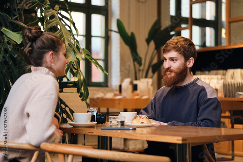 Young attractive couple drinking coffee resting together in cafe © Anton