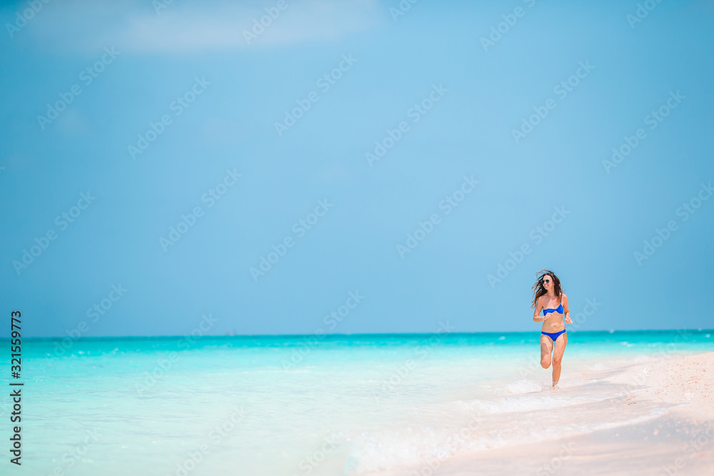 Young fashion woman in green dress on the beach Young fashion woman in green dress on the beach