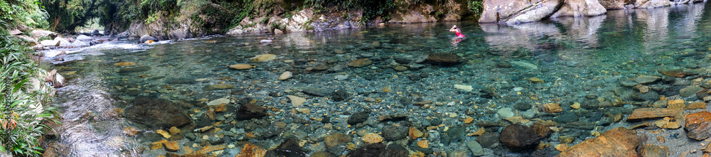 Woman in crystal clear water river in Colombia