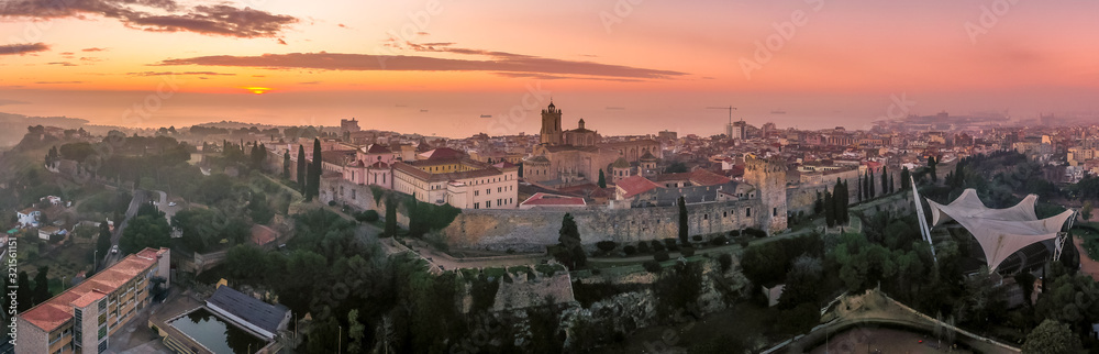 Aerial sunrise view of the medieval walled center of Tarragona in Catalunya Spain with the cathedral, city walls, bastions and towers