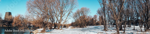 panorama of the winter snow landscape of the river and the river Bank
