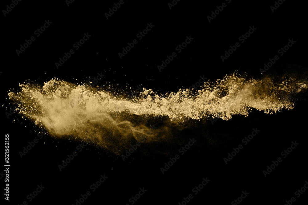 Golden powder explosion on black background. Freeze motion. Golden powder explosion on black background. Freeze motion.