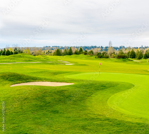 Golf course with gorgeous green and sand bunker.