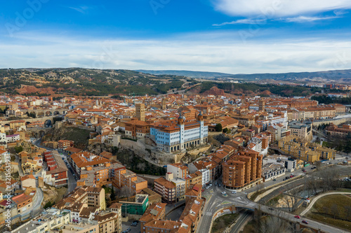 Aerial panoramic view of Teruel Spain with medieval city walls, viaduct, aquaduct and semi circular tower on a sunny winter afternoon 