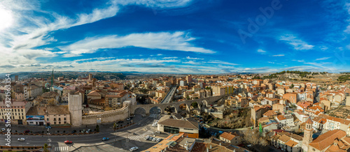 Aerial panoramic view of Teruel Spain with medieval city walls, viaduct, aquaduct and semi circular tower on a sunny winter afternoon 