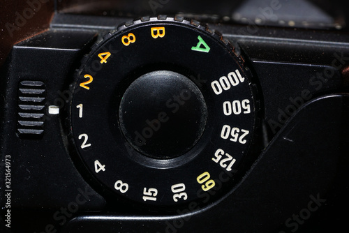 Setting wheel for ISO and aperture on an old camera photographed in the studio