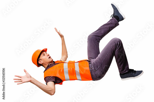 Fototapeta Leg and yellow helmet of injured lying worker at work.