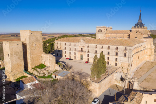 Aerial sunny afternoon view of Ucles castle and monastery historic medieval walled town in Cuenca province Spain photo