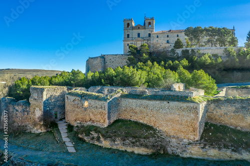 Aerial view of Ucles castle and monastery with two keeps gates and towers encircling a bailey in Cuenca Spain photo