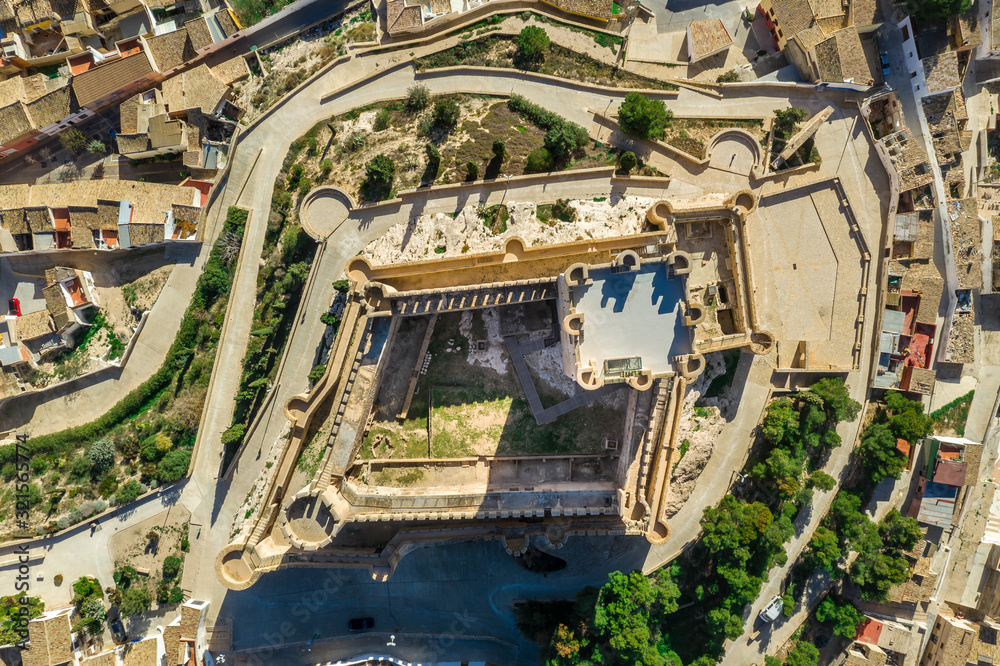Aerial view of Atalaya castle over Villena Spain. The fortress has concentric plan, with a rectangular barbican forming space in front of the keep.  The external wall has chemin-de-ronde or wall-walk