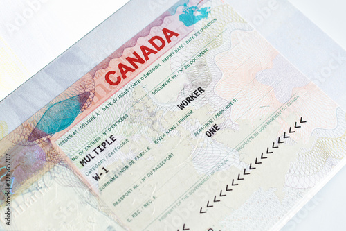 Canadian working visa in passport. Immigration to Canada concept.
