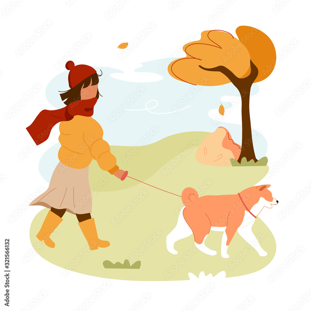 Girl walking dog on leash in autumn park