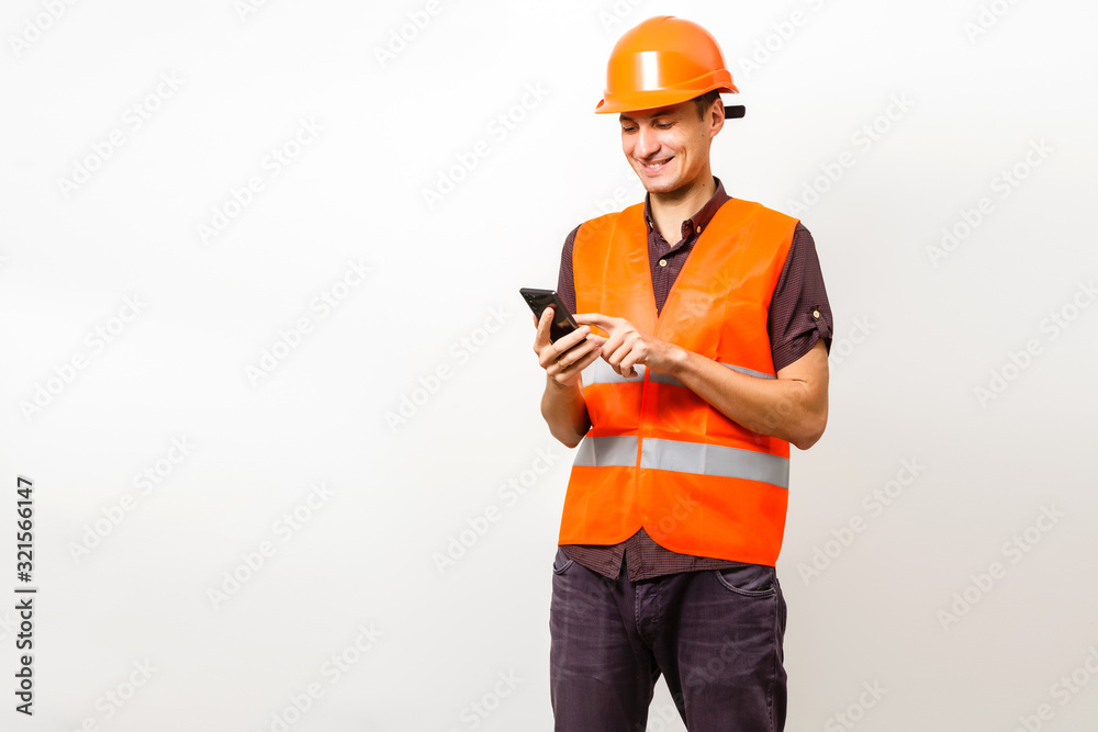 Architect on the phone and protective helmet isolated on white Architect on the phone and protective helmet isolated on white