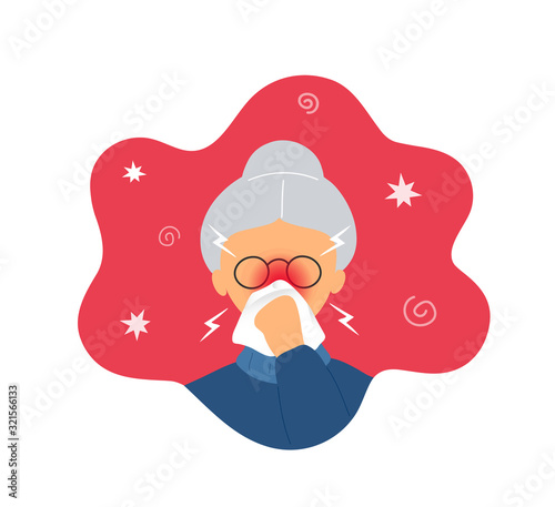Old woman with rhinitis blowing nose into napkin