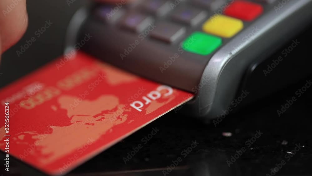 Credit card machine for money transaction. Woman hand with credit card swipe through pos terminal and enter pin code. Banking services of electronic money. Financial success and safety Credit card machine for money transaction. Woman hand with credit card swipe through pos terminal and enter pin code. Banking services of electronic money. Financial success and safety