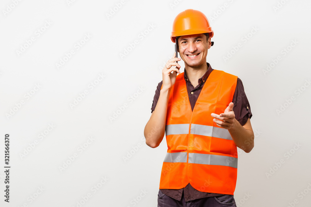 Architect on the phone and protective helmet isolated on white Architect on the phone and protective helmet isolated on white
