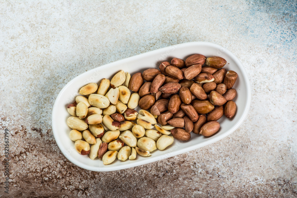 Peanuts in a white cup an old wooden floor. ramadan food. healthy nutrition. healthy food. vegetarian snack Peanuts in a white cup an old wooden floor. ramadan food. healthy nutrition. healthy food. vegetarian snack