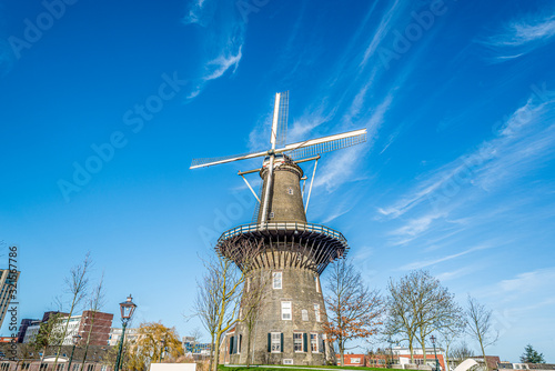 Old dutch windmill against blue sky