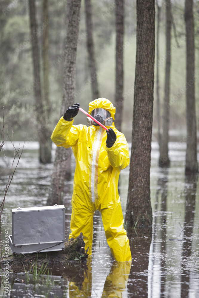 professional in protective coveralls with mini lab testing contaminated environment