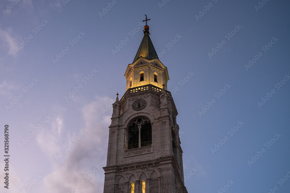 Spire of the Catholic Parish Church in Cortina d' Ampezzo Santi Filippo e Giacomo, in Belluno, Italy, at Dusk