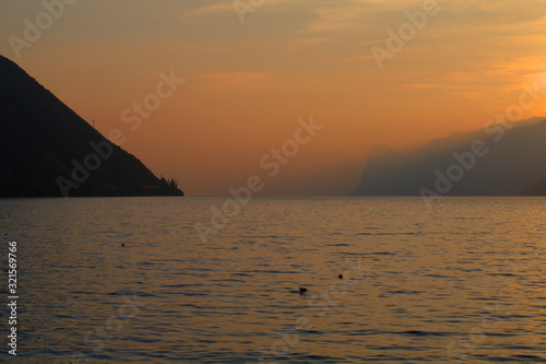 sunset at the lake water  sky view nature mountains  orange light  cloud  dawn  