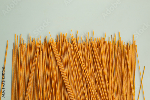 Whole grain spaghetti with complex carbohydrates on a gray background. Healthy food.
