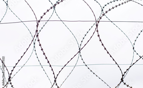 barbed wire on gray sky background