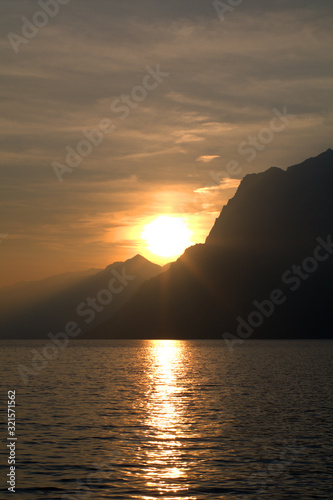 sunset over the sea sun  sky  water  clouds mountains  coast  evening reflection beautiful  color  