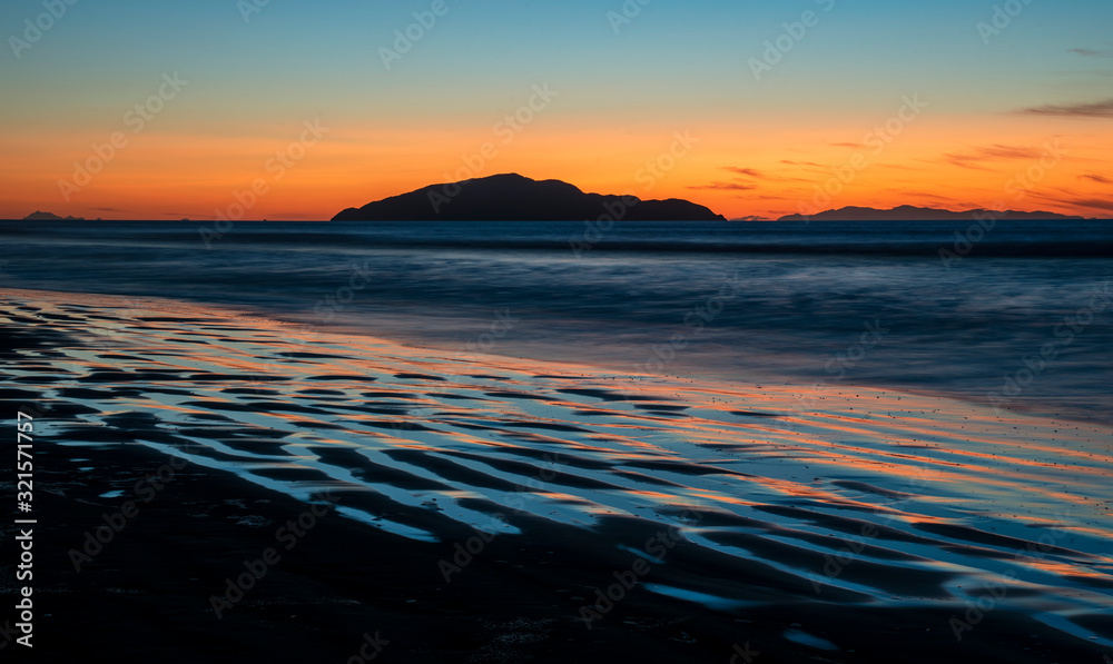 Sunset shot of Kapiti Island from Otaki beach in New Zealand with long exposure