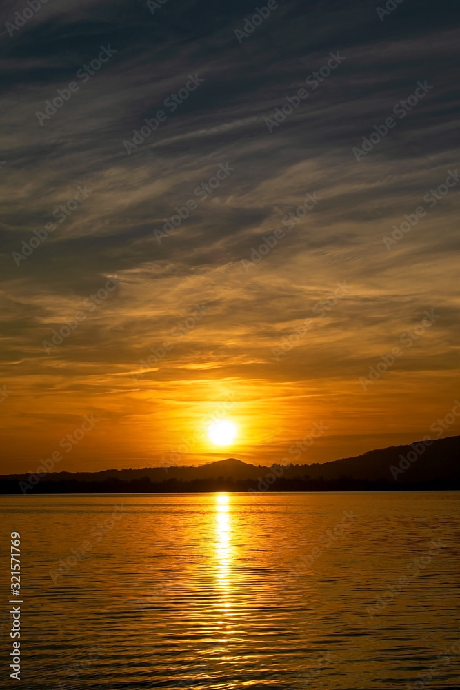 a romantic sunset on Lake Pusiano in Italy. 