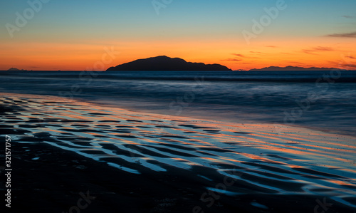Sunset shot of Kapiti Island from Otaki beach in New Zealand with long exposure