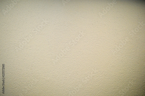Wall of beige rough embossed building decorative stucco. Texture, background