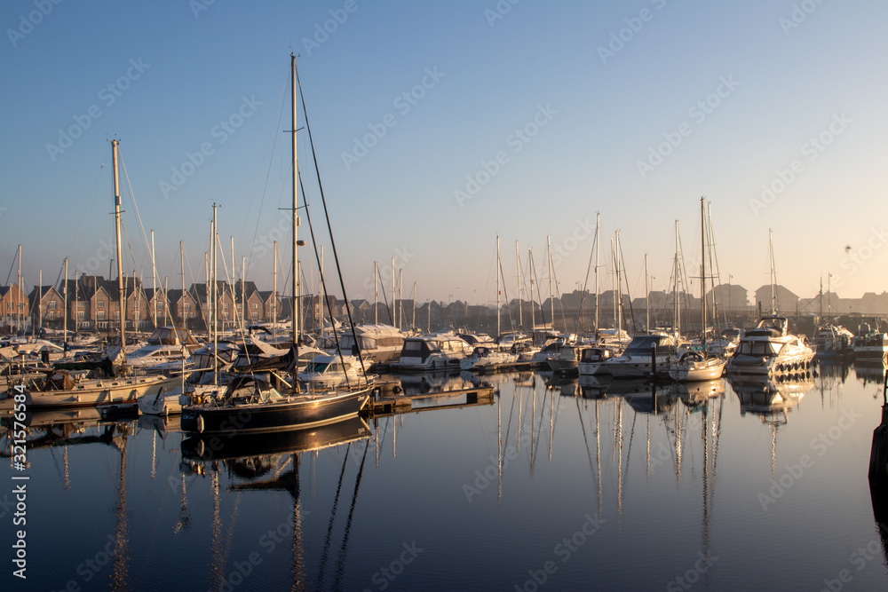 yachts moored on the marina quayside in morning