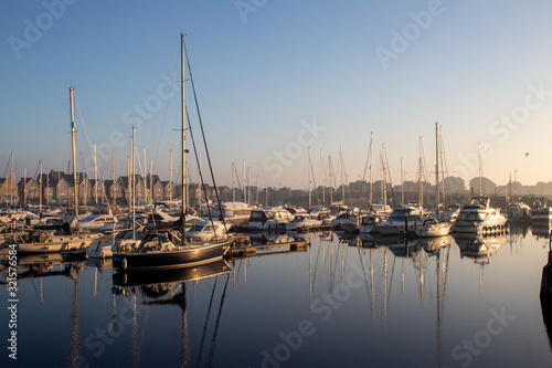 yachts moored on the marina quayside in morning © John