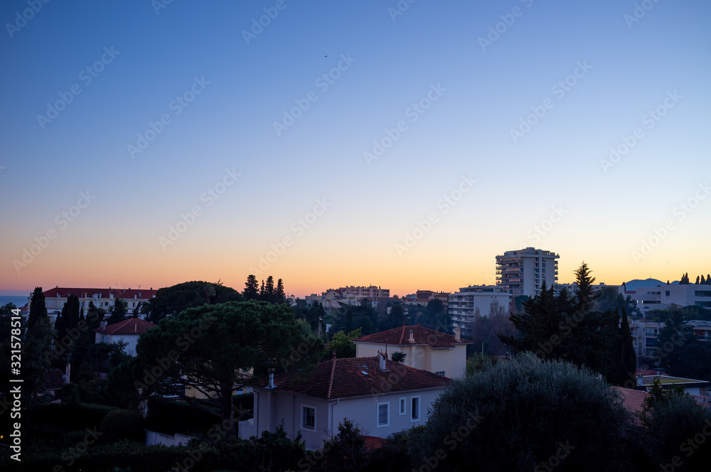view of Cannes, France hill district buildings at sunset
