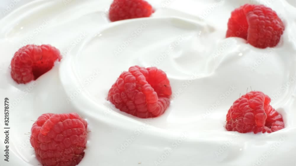 closeup of rotating yogurt with raspberries closeup of rotating yogurt with raspberries