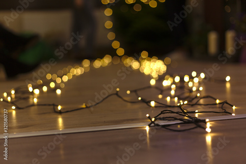 Lights string on the floor, in golden colors with sharp foreground blending in a blurry background with cascading effect