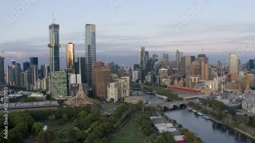 4K aerial footage approaching Flinders Street Staion and heading towards Melbourne CBD at sunrise photo