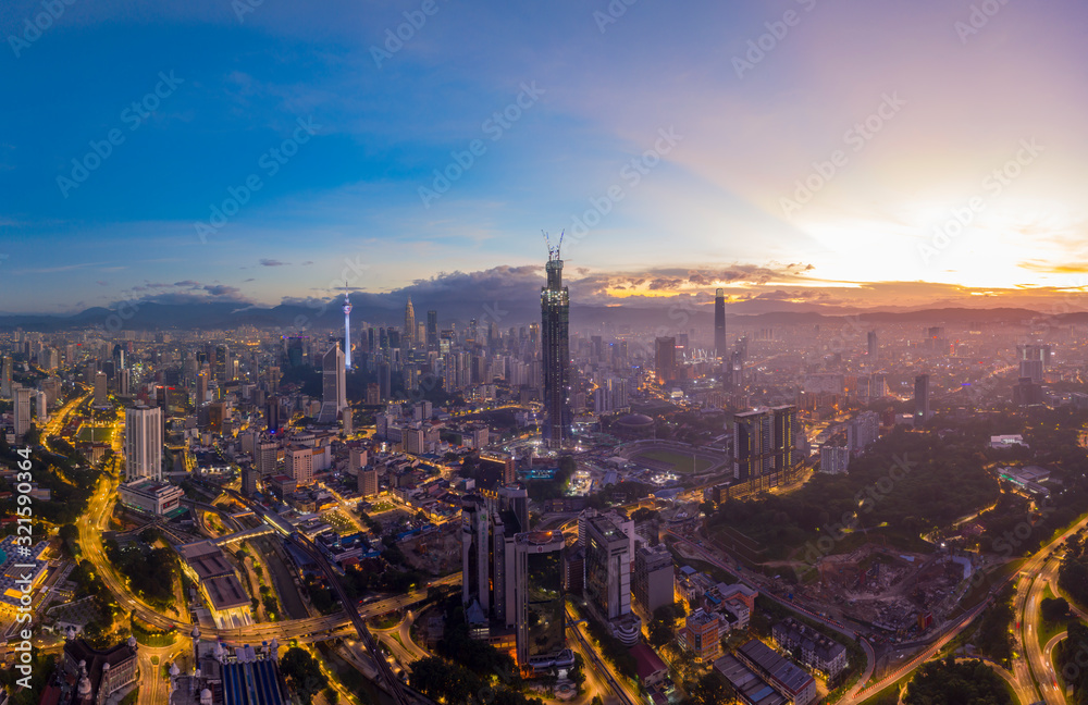 Aerial panoramic view of sunrise over Kuala Lumpur city skyline. 