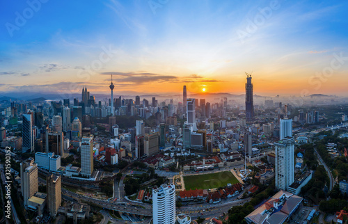 Aerial panoramic view of sunrise over Kuala Lumpur city skyline. © mezairi